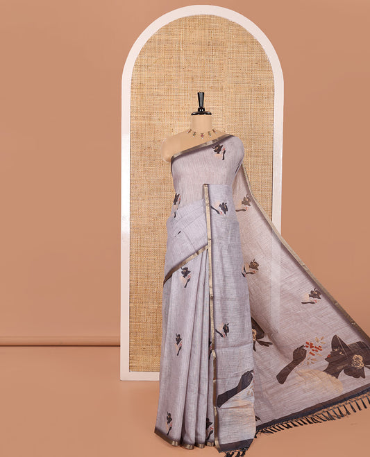 Grey Linen Saree Creatively Printed with Girl Motifs All Over Its Body, Subtly Sparkled with Piping Zari Border, Pallu Mirrors the Same Body Print, and Paired with a Contrast-Printed Blouse