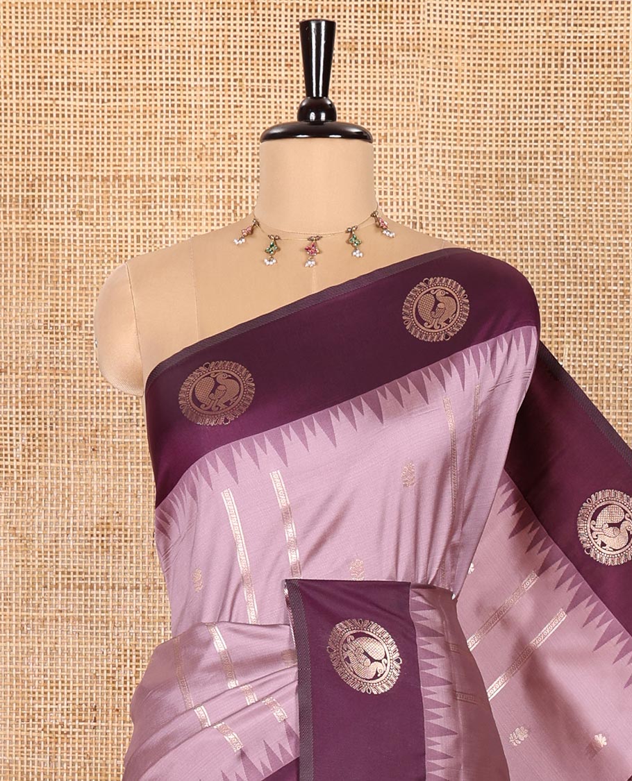 Lavender Elite Soft Silk Saree, Richly Detailed with Zari Buttas and Zari Stripes All Over Its Body, Complemented by a Contrast Temple Border of Round Peacock Designs, Rich Pallu of Peacock Chakram Butta Enclosed Checks, and Paired with a Contrast Blouse