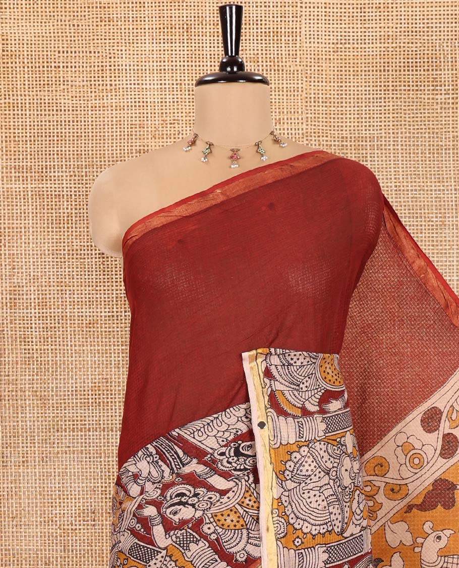 Maroon Kota Cotton Saree, Artfully Decked Up with Kalamkari-Style Human Figurines Printed on the Body, Subtle Piping Border, Pallu Pictures Kalamkari-Style Flora-Fauna Motifs, and Paired with a Contrast-Printed Blouse