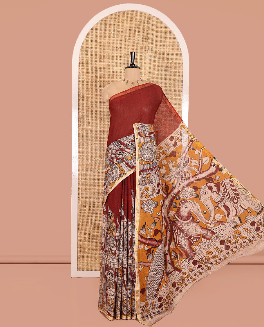 Maroon Kota Cotton Saree, Artfully Decked Up with Kalamkari-Style Human Figurines Printed on the Body, Subtle Piping Border, Pallu Pictures Kalamkari-Style Flora-Fauna Motifs, and Paired with a Contrast-Printed Blouse