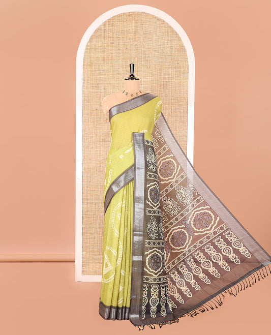 Green Linen Cotton Saree, Adorned with Shibori Printed on Its Body, Complemented by a Contrast Bavanji Zari Border, Handblock Printed Pallu, and Paired with a Contrast Blouse