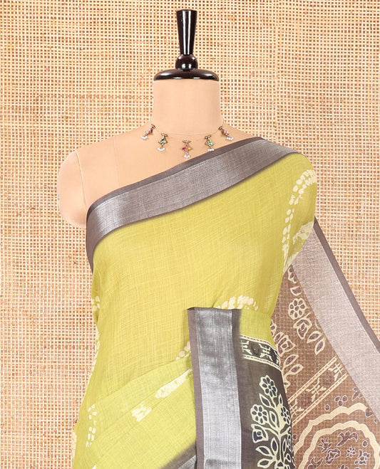 Green Linen Cotton Saree, Adorned with Shibori Printed on Its Body, Complemented by a Contrast Bavanji Zari Border, Handblock Printed Pallu, and Paired with a Contrast Blouse
