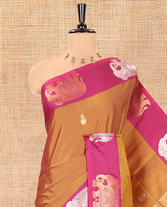 Brown Soft Silk Saree, Adorned With Zari Buttas All Over Its Body, Complemented by Captivating Contrast Border of Elephant Motifs, Grandly Decked Up Pallu, and Paired with a Contrast Blouse