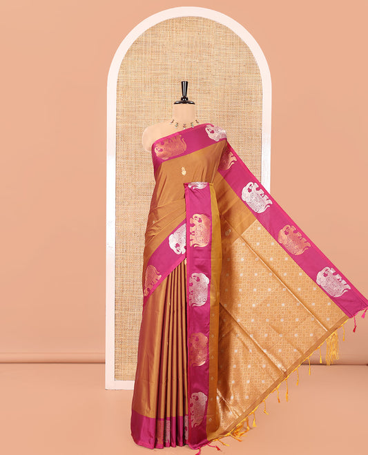 Brown Soft Silk Saree, Adorned With Zari Buttas All Over Its Body, Complemented by Captivating Contrast Border of Elephant Motifs, Grandly Decked Up Pallu, and Paired with a Contrast Blouse