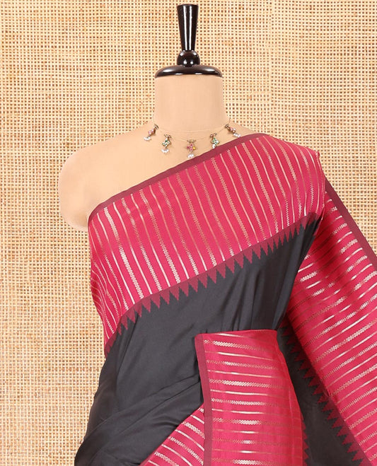 Black Elite Soft Silk Saree, Highlighted by Zari Buttas All Over Its Body, Complemented by Contrast Border Steeped with Geometric Patterns, Grand Pallu, and Paired with a Contrast Blouse