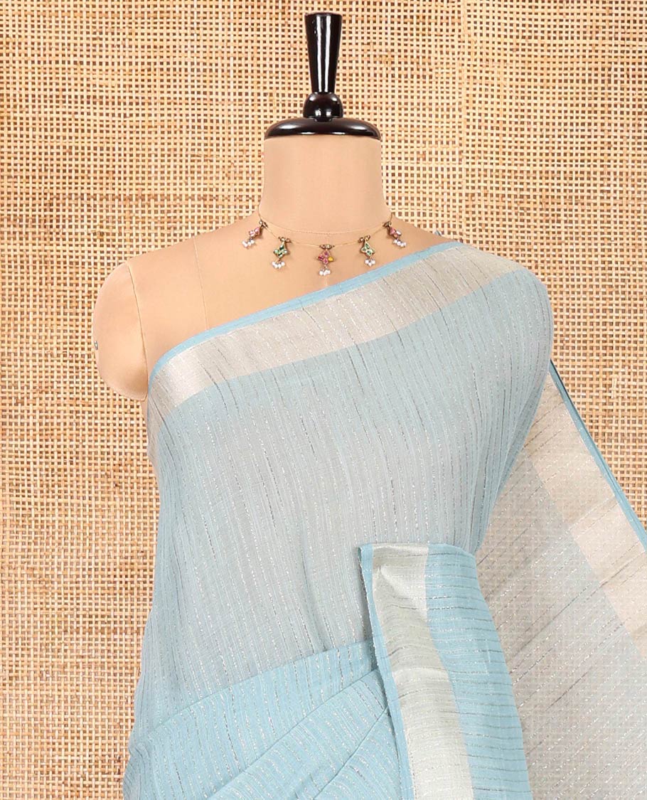 Rama Green Linen Zari Cotton Saree, Gleamed Up with Zari Stripes All Over Its Body, a Subtle Zari Border, a Self-Pallu, and Comes Without a Blouse