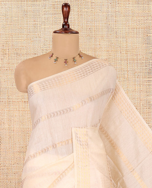 Cream Bhagalpur Cotton Saree, Gleamed Up with Zari Designs, a Subtle Zari Border, Gleaming Pallu, and a Matching Blouse