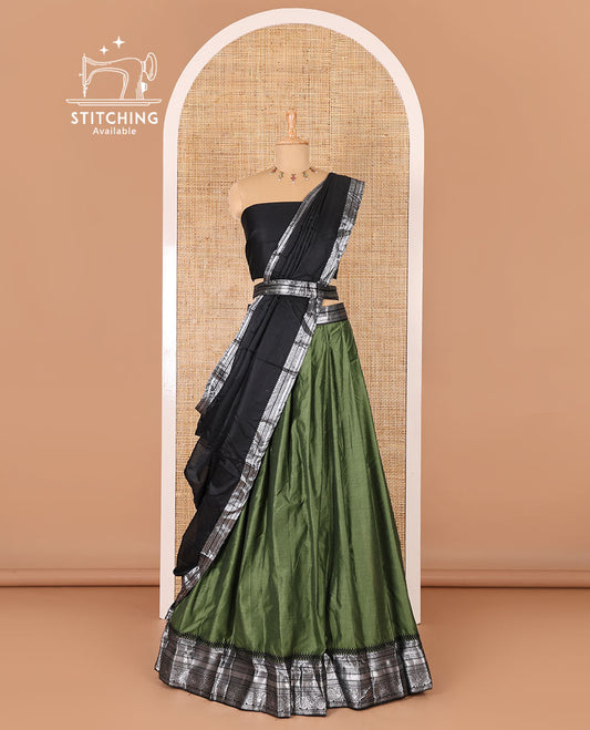 Green taffeta silk half-saree, plain with a contrast traditional design bordered skirt, contrast blouse, and traditional zari bordered blouse