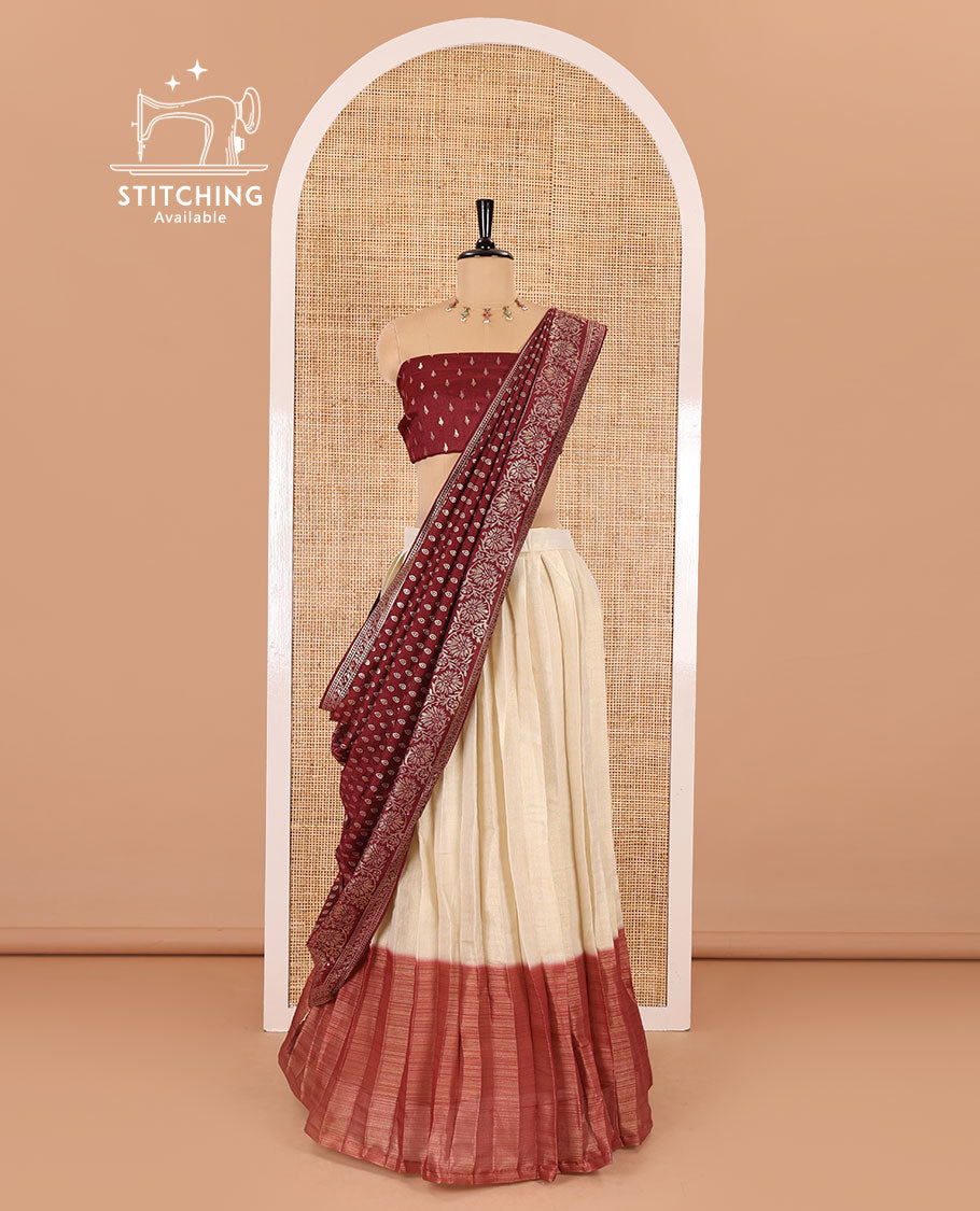 Cream-maroon Vichitra half-saree, plain and contrast bordered skirt, contrast leaf buttas blouse, dhavani of buttas and floral creeper designs