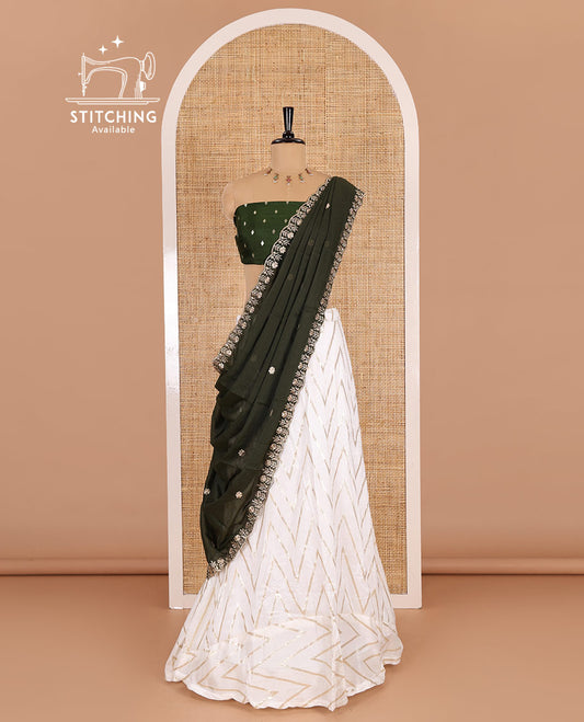 Cream-mehendi green half-saree, gold chevron striped nylon viscose crepe skirt, contrast diamond buttas blouse, and  a contrast scallop floral-theme embroidered dhavani