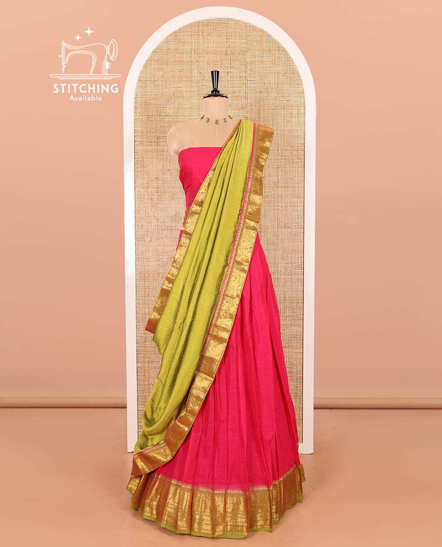 Rani Pink and Parrot Green Chettinad Cotton Half-Saree Featuring a Plain Skirt, Highlighted with a Contrast Floral-Peacock Zari Border, a Subtly Woven Matching Blouse, and a Vichitra Silk Contrast Traditional Zari Bordered Dhavani
