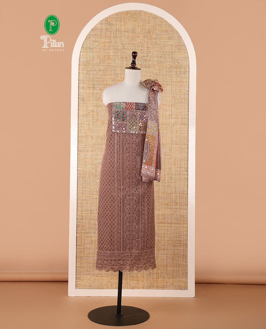 Brown churidar material set, Ajrakh-printed neck with Schiffli embroidery & mirror work georgette top, kalidoscopic-colored dupatta of ajrakh print & mirror embroidery & plain crepe bottom