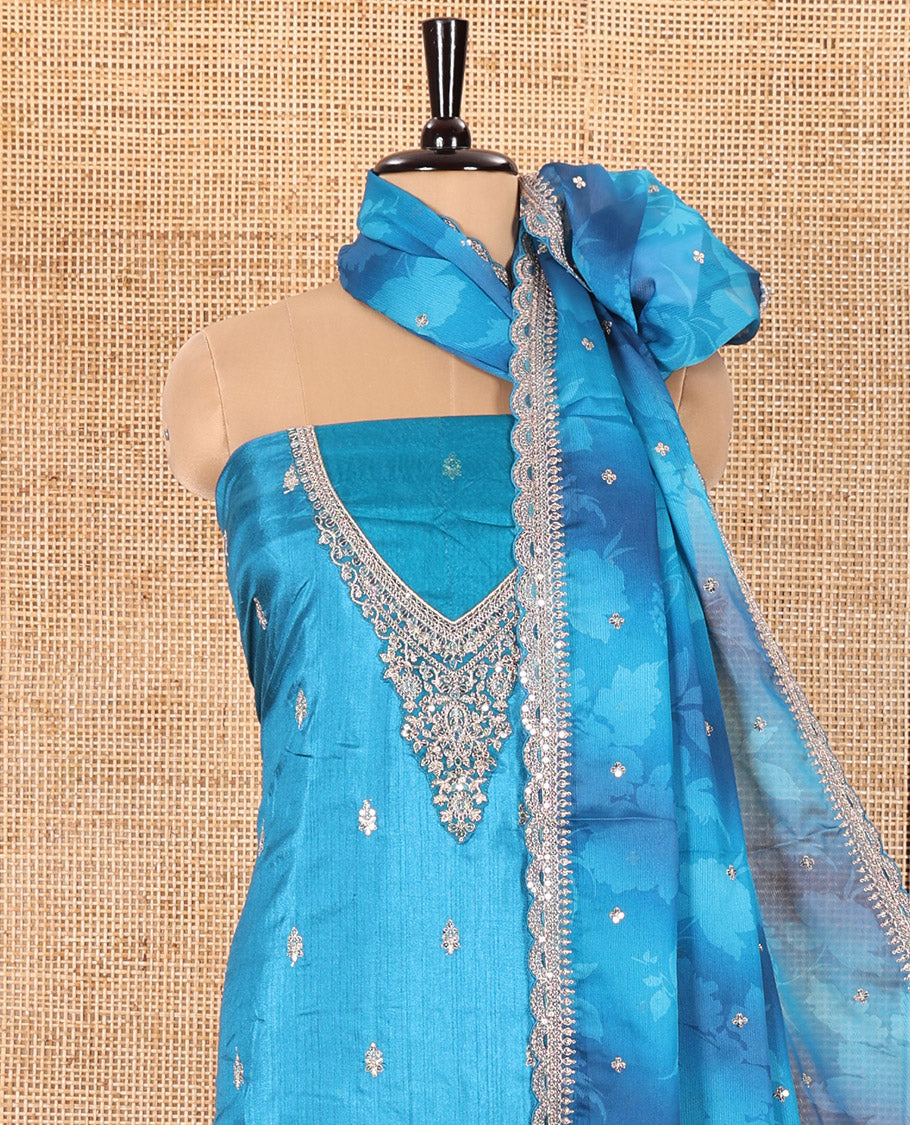 Blue Material Chudidar Set Mesmerized with Intricately Embroidered Muga Silk Top, Subtly Made Plain Santoon Bottom, and a Bemberg Chiffon Dupatta Featuring Floral Printed, and Embroidery