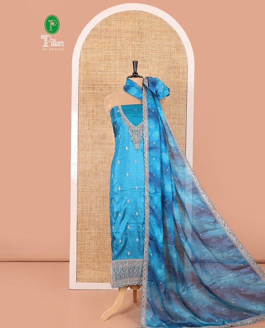 Blue Material Chudidar Set Mesmerized with Intricately Embroidered Muga Silk Top, Subtly Made Plain Santoon Bottom, and a Bemberg Chiffon Dupatta Featuring Floral Printed, and Embroidery
