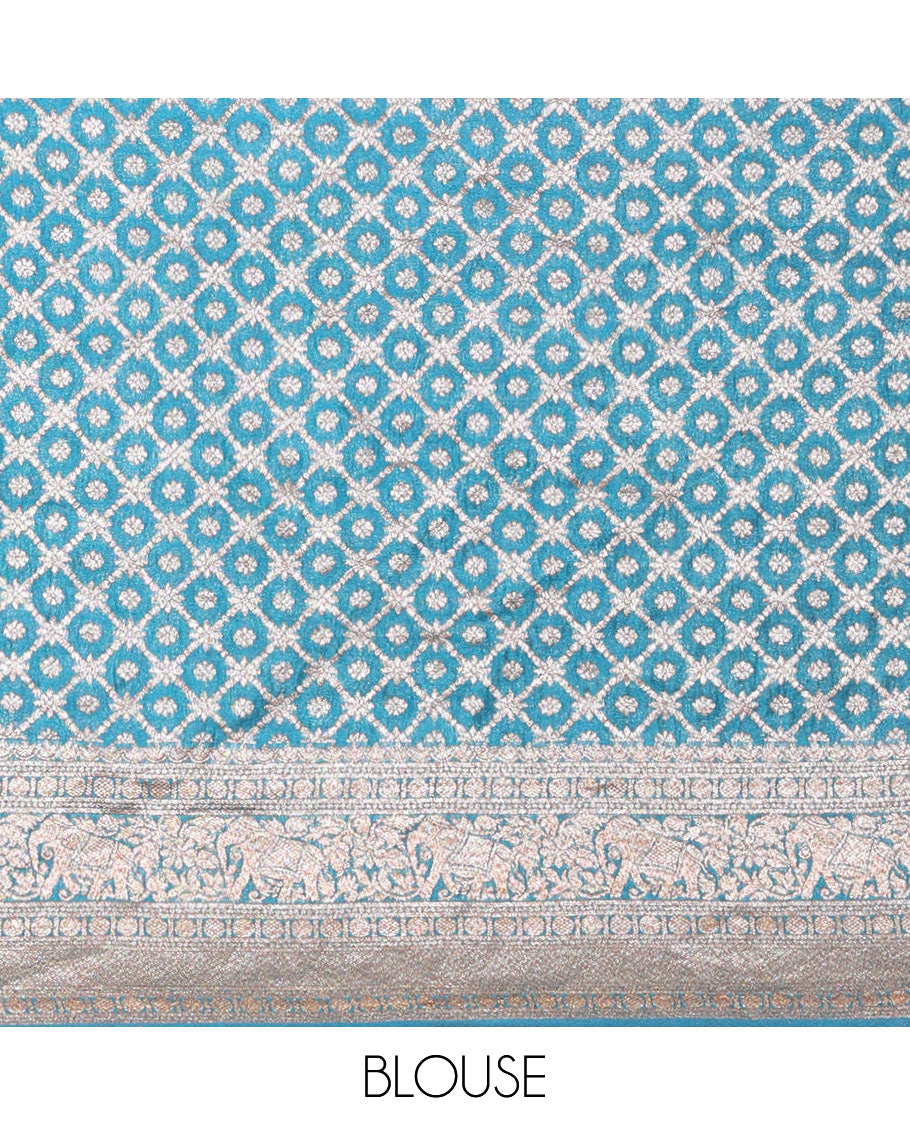 Blue Semi-Banaras Khaddi Georgette Embellished with Zari Buttas All Over Its Body,  Subtly Sparkled Traditional Border of Rudraksham, Elephant, and Floral Vine Designs, Pallu of a Herd of Elephants, and Paired with a Matching Blouse