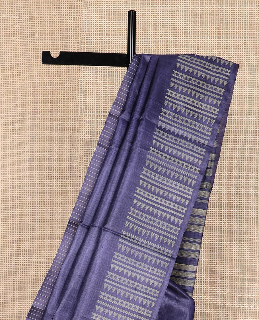 Blue plain tussar silk saree, self border and pallu features geometric patterns, and temple motifs