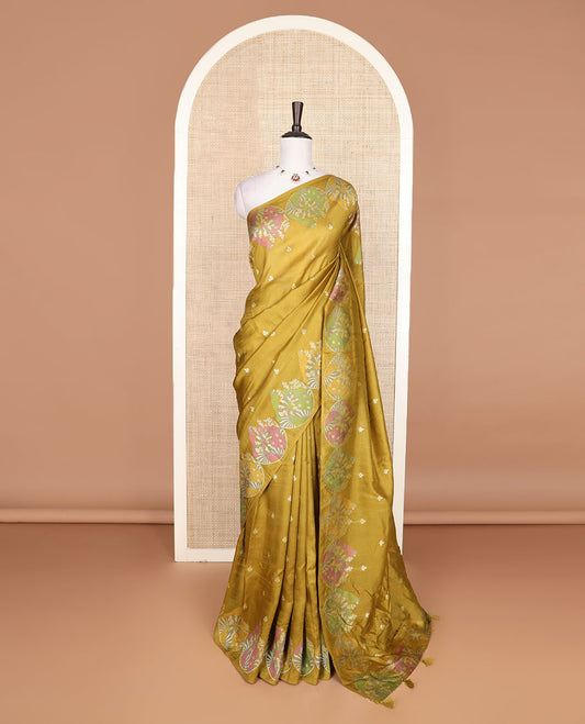 Borderless mustard Matka silk saree features floral and scallop bird motifs in meenakari style