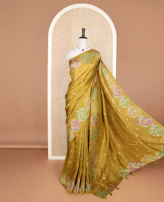 Borderless mustard Matka silk saree features floral and scallop bird motifs in meenakari style