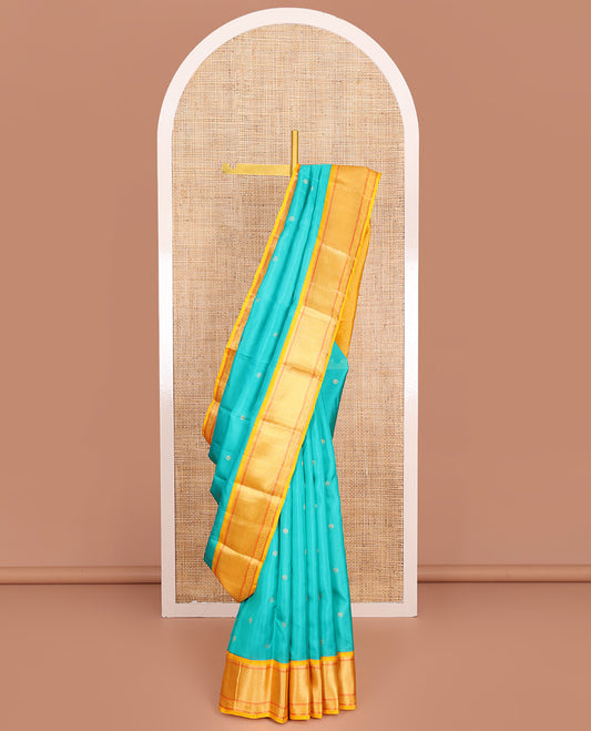 Blue Vasundhara Lite-Silk Mix Saree, Mesmerized with Zari Buttas All Over Its Body, Complemented by Contrast Border Featuring Thilakam Mokku, Muthu, Mayil Kann, and Kodi Visiry Designs, Grand Jaal Pallu, and Paired with a Contrast Blouse