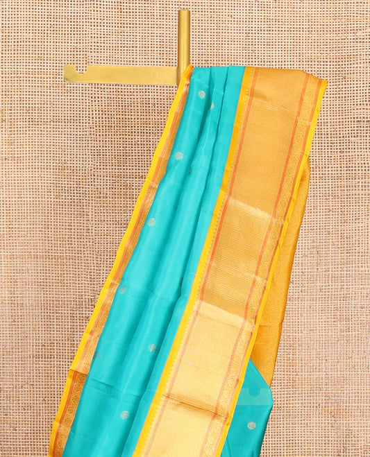 Blue Vasundhara Lite-Silk Mix Saree, Mesmerized with Zari Buttas All Over Its Body, Complemented by Contrast Border Featuring Thilakam Mokku, Muthu, Mayil Kann, and Kodi Visiry Designs, Grand Jaal Pallu, and Paired with a Contrast Blouse