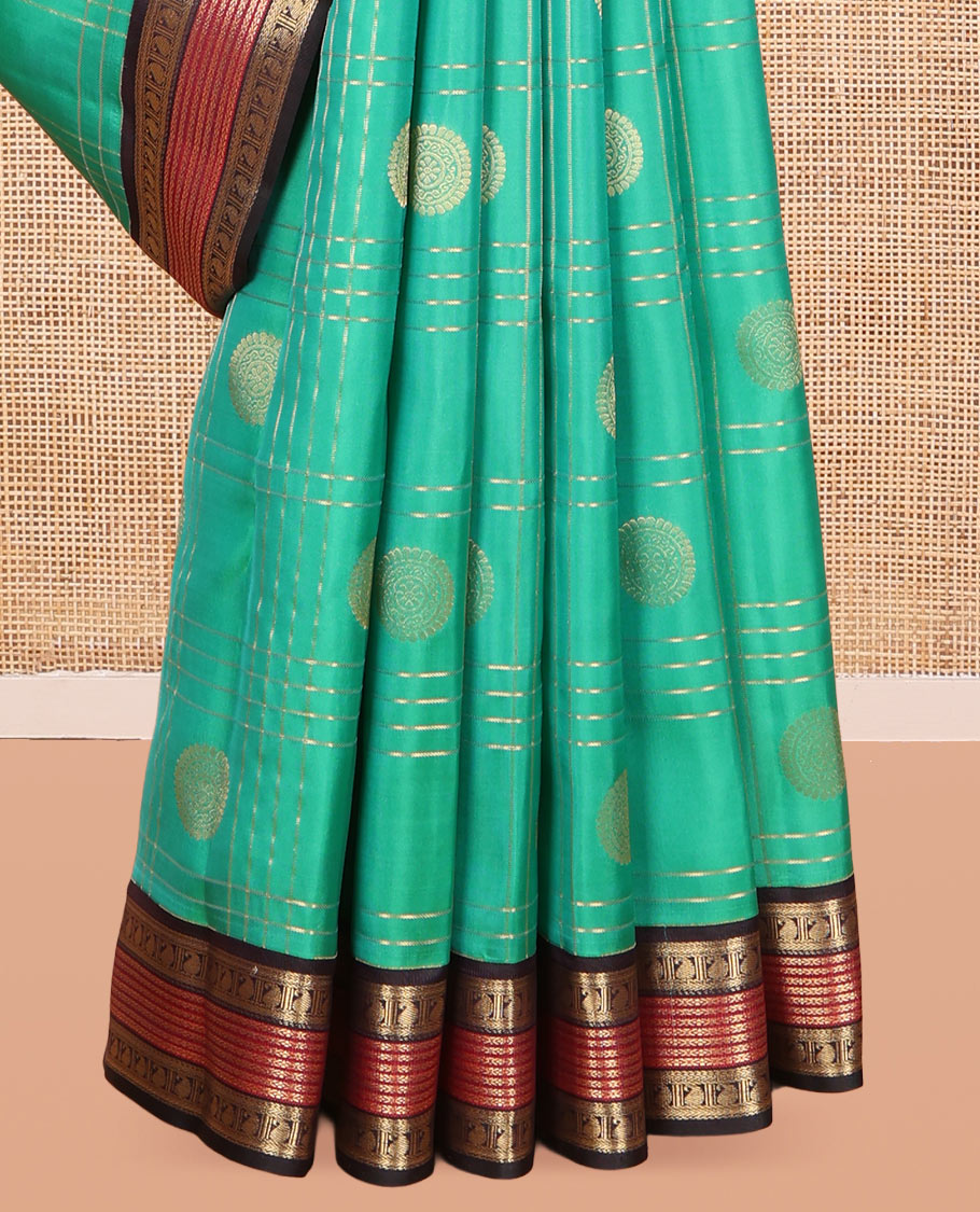 Green Vasundhara Lite Silk Mix Saree Features Butta Enclosed Checks, a Contrast Manga Design Border, Mayil-Chakram Pallu, and Contrast Blouse