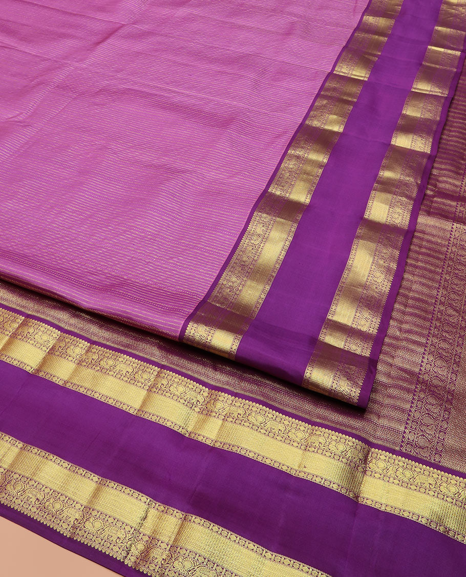 Pink Vasundhara Silk Saree Accentuated with Zari Stripes, Complemented by a Contrast Border of Salangai, Rudraksham, Star, Kodi Mayil, Yaanai, and Mayil Kann Designs, Pallu Decked Up with Traditional Designs, and Paired with a Contrast Blouse