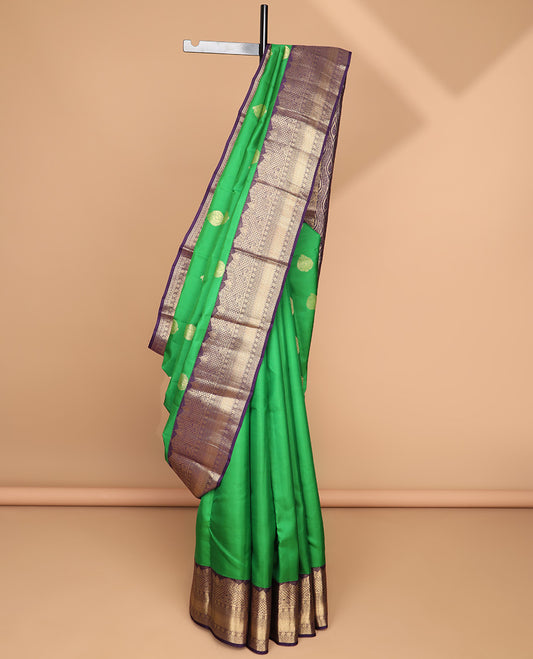 Green leaf buttas silk saree with contrast border of intracate zari design & floral design pallu