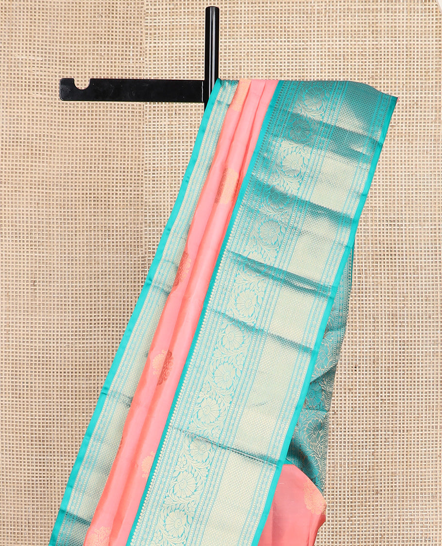 Pink zari buttas silk saree, contrast border of thilakam mokku, muthu, lavangam, kodi visiry, and kuyil kann designs, and chakram motifs steeped pallu