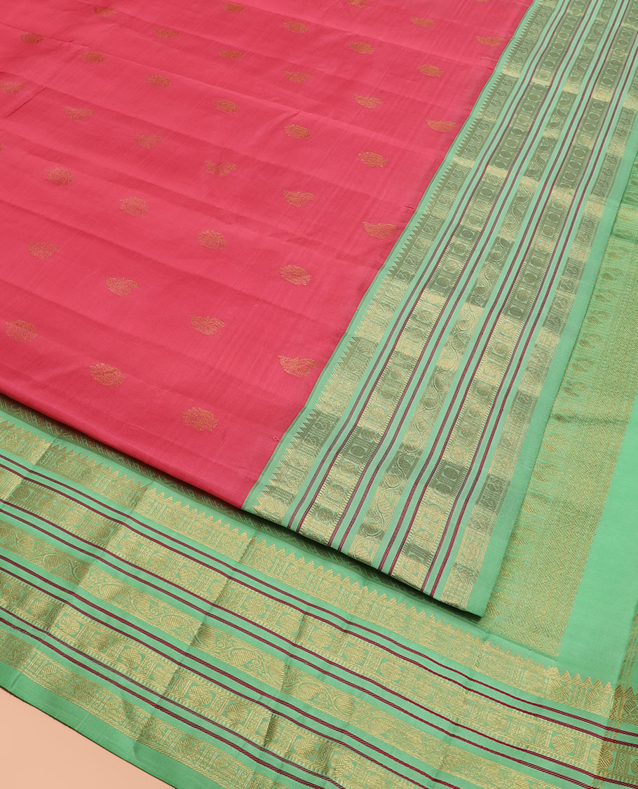 Red Vasundhara Silk Saree Subtly Woven with Zari Buttas, Complemented by a Contrast Varisai Pettu Border of Rekku, Mayil, Rudraksham, and Manga Designs, Pallu Adorned with Traditional Designs, and Paired with a Contrast Zari-Bordered Blouse