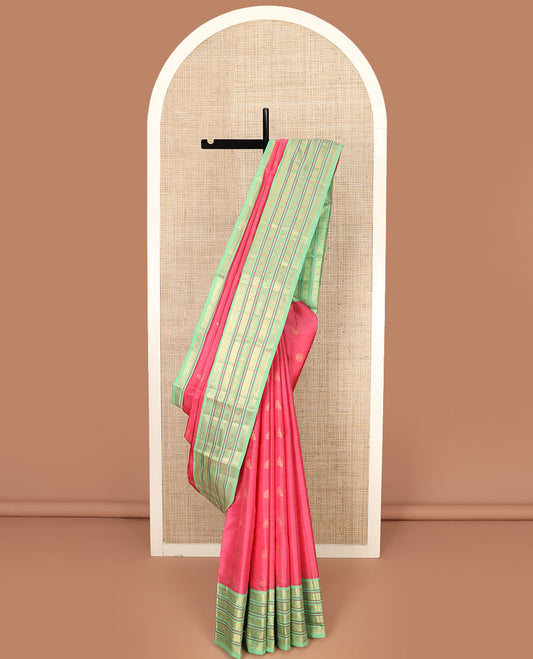 Red Vasundhara Silk Saree Subtly Woven with Zari Buttas, Complemented by a Contrast Varisai Pettu Border of Rekku, Mayil, Rudraksham, and Manga Designs, Pallu Adorned with Traditional Designs, and Paired with a Contrast Zari-Bordered Blouse