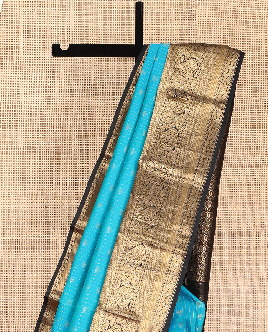Blue Vasundhara Silk Saree, Adorned with Zari Buttas All Over Its Body, Complemented by Contrast Border of Rekku, Lavangam, Diamond, Mayil Kann, and Arumbu Manga Designs, Pallu of Mughal-Style Jaal Designs, and Paired with a Contrast Blouse