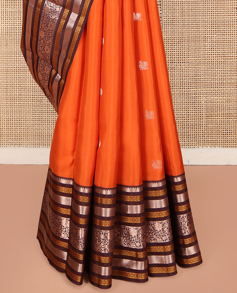 Orange Vasundhara Silk Saree, Adorned with Annam Chakram Buttas All Over Its Body, Complemented by Contrast Border of Thilakam, Neli, Laddu Kamalam, Mayil Kann, and Kodi Visiry Designs, Pallu of Butta Enclosed Checks, and Paired with a Contrast Blouse