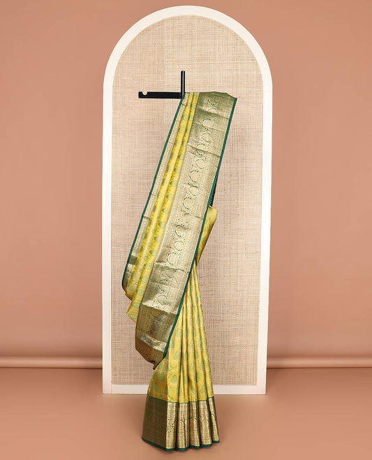 Green jacquard Kanchipuram wedding silk saree, contrast border of thilakam, banaras, neli, mayil, kuthirai, chakram, and zari designs, and geometric patterned pallu