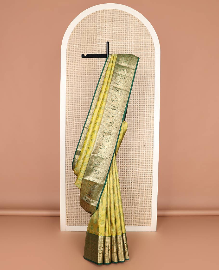 Green jacquard Kanchipuram wedding silk saree, contrast border of thilakam, banaras, neli, mayil, kuthirai, chakram, and zari designs, and geometric patterned pallu