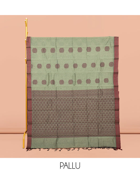 Green Semi-Silk Cotton Saree, Adorned with Round Buttas on Its Body, Complemented by a Contrast Thread Traditional Motifs Woven Border, Jaal Design Pallu, and Paired with a Contrast Blouse