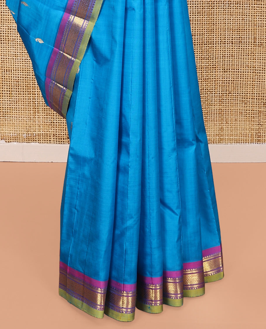 Blue Kanchipuram Silk Saree, Adorned with Zari Buttas All Over Its Body, Complemented by a Contrast One-Sided Border of Rekku, Banaras, and Mayil Kann Designs, Pallu of Zari Designs, and Comes Without a Blouse