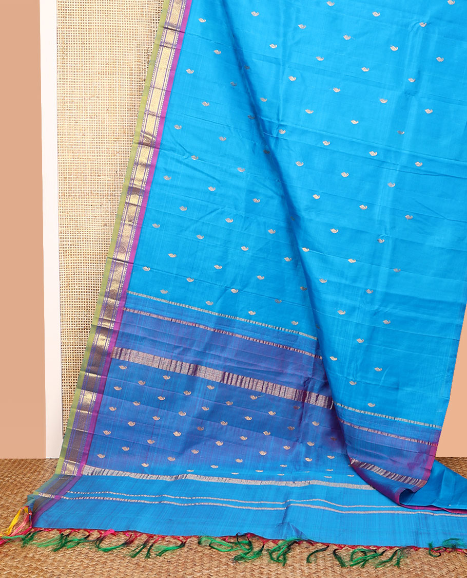 Blue Kanchipuram Silk Saree, Adorned with Zari Buttas All Over Its Body, Complemented by a Contrast One-Sided Border of Rekku, Banaras, and Mayil Kann Designs, Pallu of Zari Designs, and Comes Without a Blouse