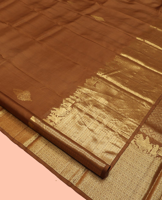 Brown Kanchipuram Silk Saree, Elevated with Zari Buttas All Over Its Body, Highlighted by Zari Wedding-themed Border of Manga, and Kamalam Designs, Grand Jaal Pallu, and Paired with a Matching Blouse
