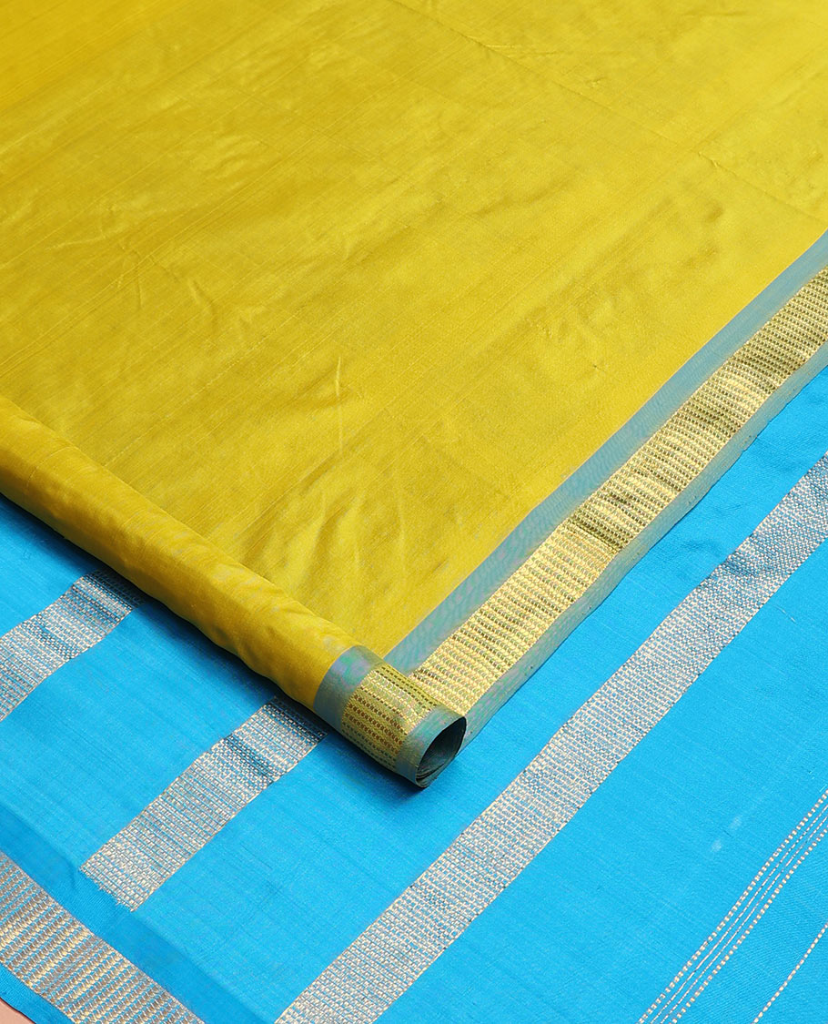 Green plain nine-yard silk saree, contrast border of Muthu designs, and pallu of zari designs