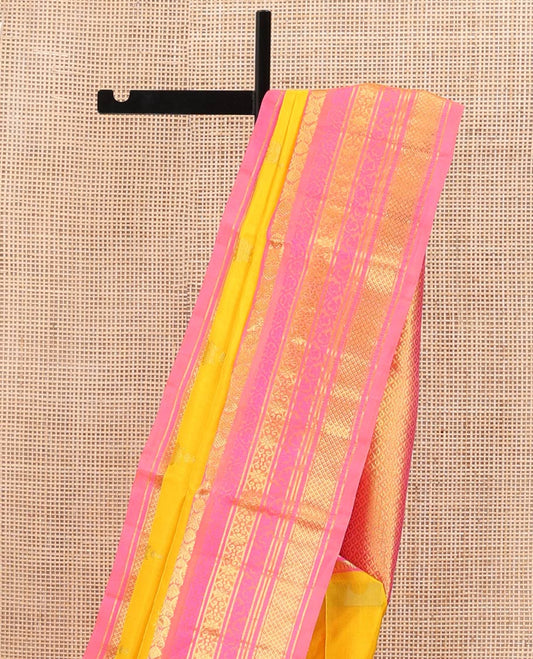 Yellow Venkatagiri Silk Saree, Sparsely Woven with Zari Buttas All Over Its Body, Complemented by a Contrast Border of Temple, Floral, and Peacock-Eye Designs, Pallu of Peacock Eye Designs, and Paired with a Contrast Blouse