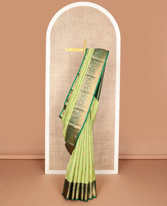 Green zari buttas vasundhara silk mix saree, contrast border of neli,kathir,kodi visiry & mayil kann & pallu of geometric patterns