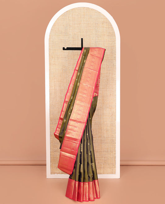 Green Vasundhara Silk Saree, Elevated with Zari Buttas on Its Body, Complemented by a Contrast Border of Thilakam Mokku, Muthu, Ara Maadam, Paisa, Kodi Visiry, and Annam Chakram Designs, Grandly Zari-Woven Pallu, and Paired with a Contrast Blouse