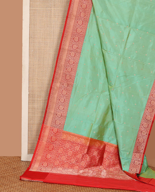 Green zari buttas katan silk saree, contrast traditional border of floral creeper design, and floral jaal pallu