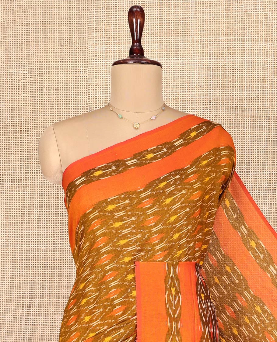Brown Ikkat Cotton Saree, Ornamented with Ikkat-Style Ogee Patterns on Its Body, Complemented by a Contrast Ikkat Border, Pallu of Ikkat-Style Buttas, and Has No Blouse