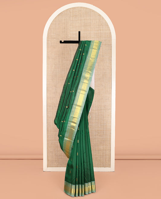Green Kanchipuram Silk Saree, Delicately Woven with Zari Buttas on Its Body, Complemented by a Contrast One-Sided Border of Panner Sombu, Banaras, and Mayil Kann Designs, Pallu of Zari Designs, and Comes Without a Blouse