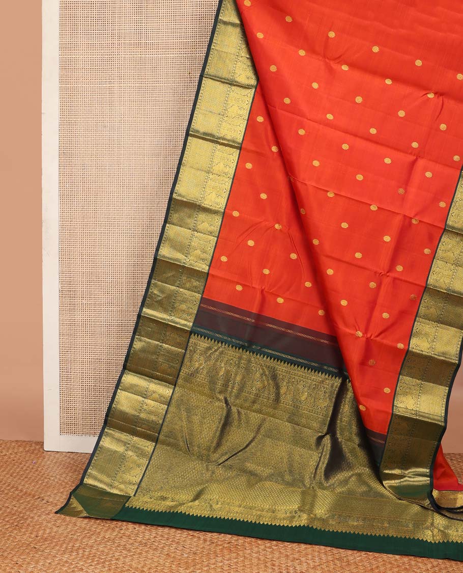 Orange chakram buttas Kanchipuram korvai silk saree, contrast neer korvai border of rekku, muthu, mayil, chakram, poun, and kuyil kann designs, and jaal pallu