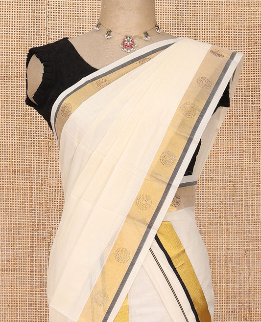 Cream plain Kerala mundu set with contrast zari border decked up with micro-stone chakram motifs