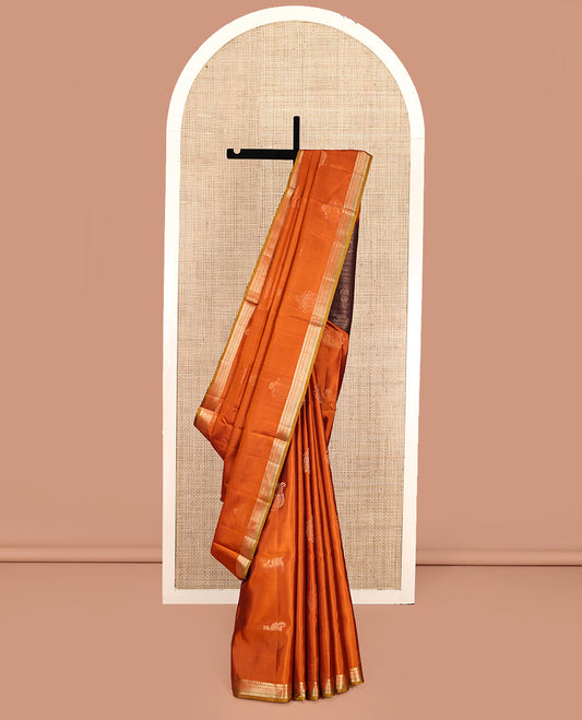 Orange Mayuri Soft Silk Saree, Accentuated with Zari Buttas All Over Its Body, Highlighted by Zari Border of Manga Mokku, and Ara Maadam Designs, and Paired with a Contrast Geometric Patterned Pallu and Paired with a Contrast Blouse