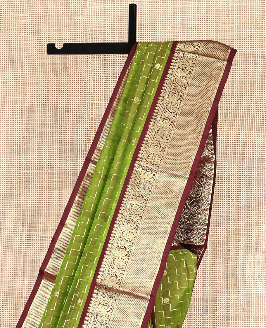 Green Venkatagiri Silk Saree, Delicately Woven with Zari Butta and Chevron Stripes All Over Its Body, Complemented by a Contrast Traditional Zari Border, Pallu of Ogee Designs, and Paired with a Contrast Blouse