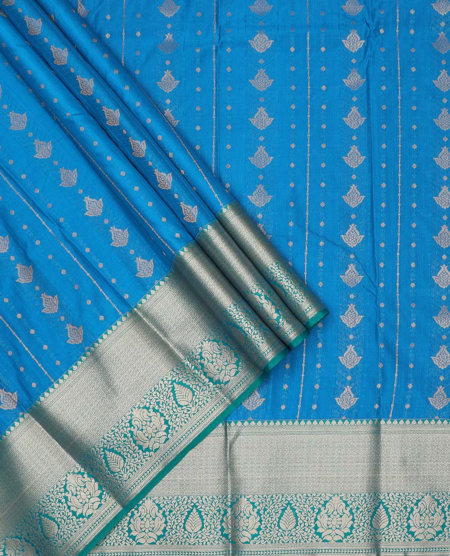 Blue art silk pavadai material, zari buttas with contrast traditional zari bordered skirt, and a contrast bordered blouse